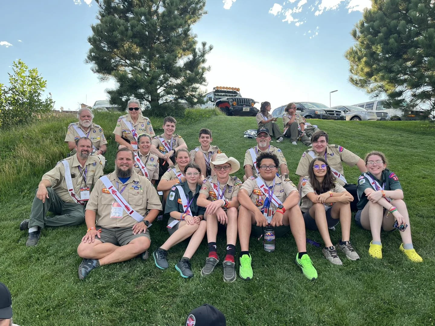 Group picture of contingent members seated on a hill